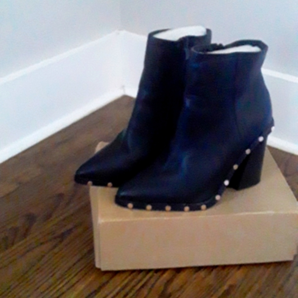 Black  leather ankle length bootie with gold studs.